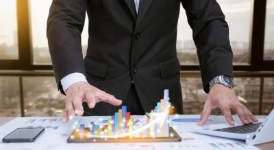 businessman-analyzing-graphs-with-technologic-devices (1)