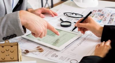 businessmen-analyzing-business-plan-tablet (1)