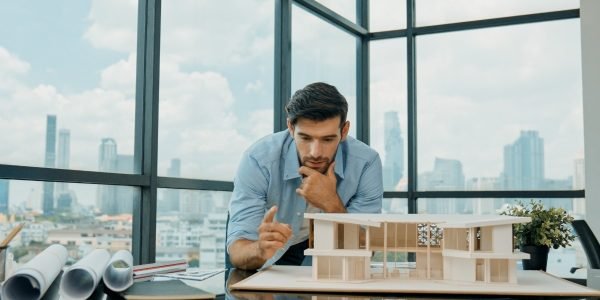 closeup-skilled-engineer-check-inspect-look-house-model-tracery (1)